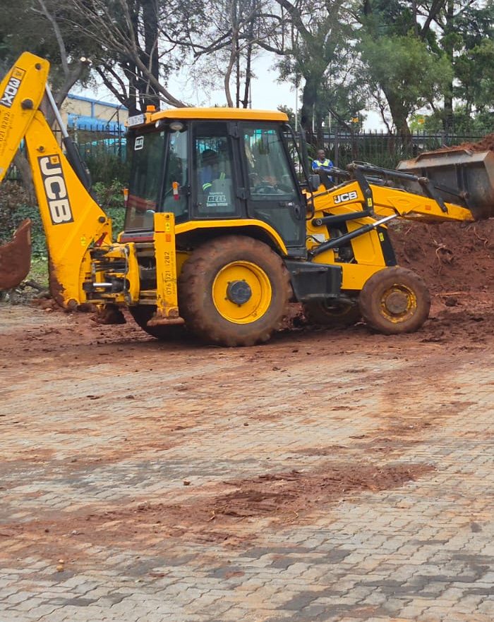JCB backhoe loader on a paved site